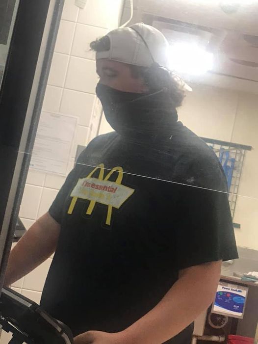 guy with a mask and a mcdonalds shirt on